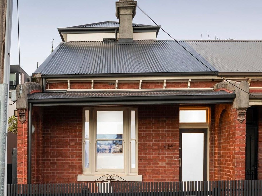 a brick building with a black roof