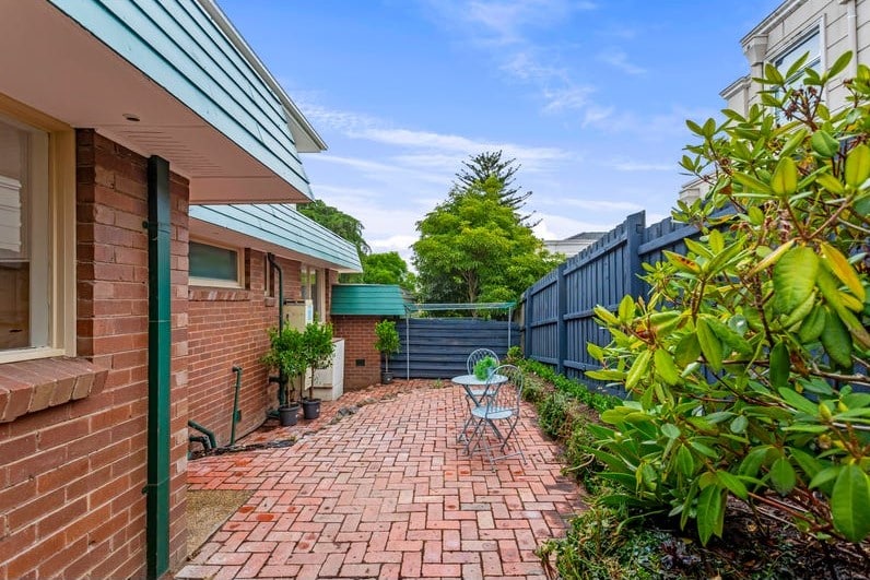 a brick walkway between buildings