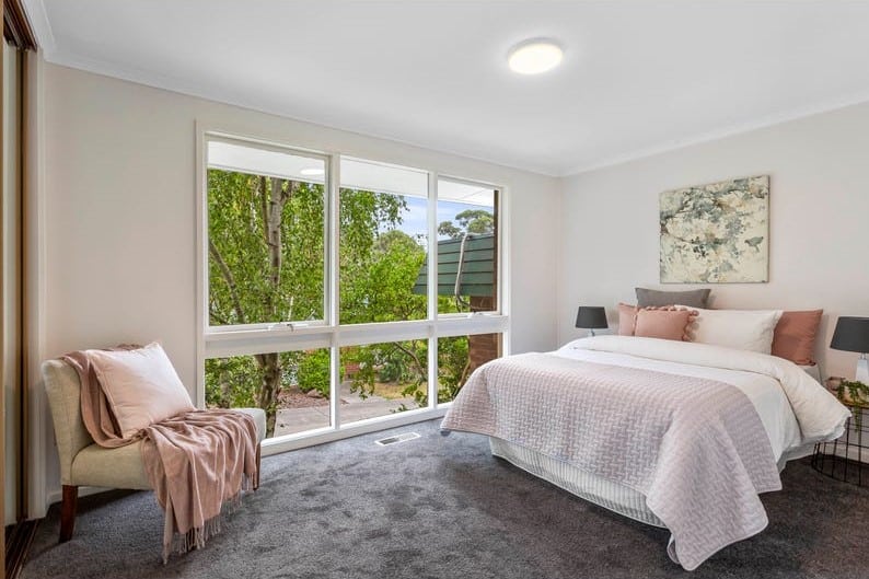 a bedroom with a large window