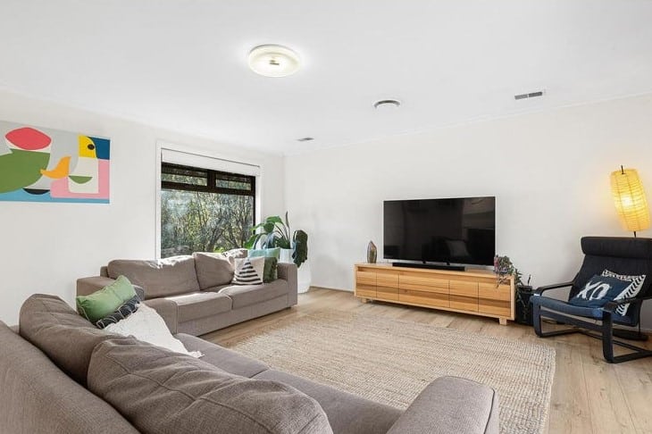 a living room with a tv and couches