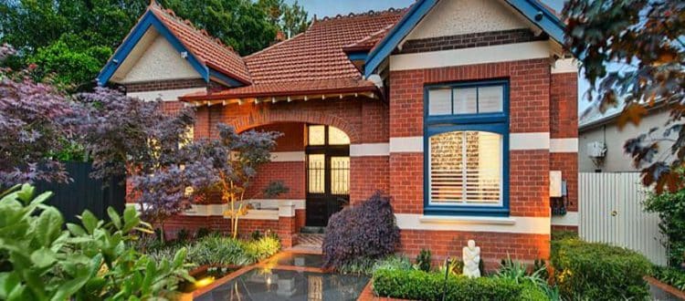 Red-brick period house with decorative gables and front steps